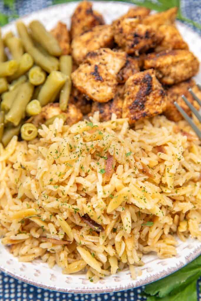 plate of rice pilaf with chicken and green beans