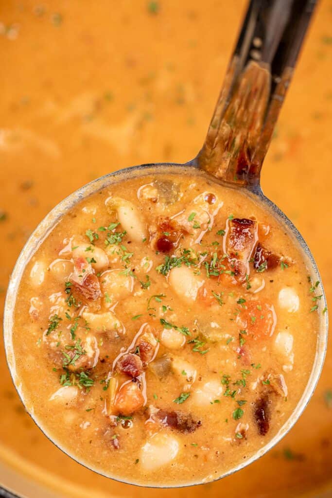 ladle of bean and bacon soup