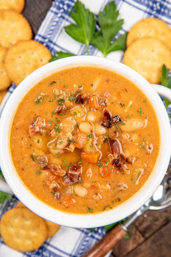 bowl of bean soup on a table with crackers